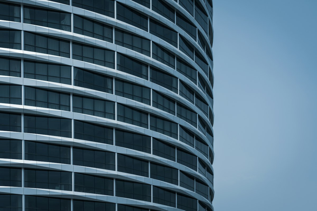 Sweeping glass façade of a modern commercial building
